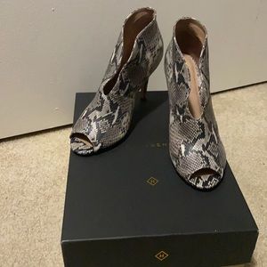 Peep-toe snakeskin bootie.